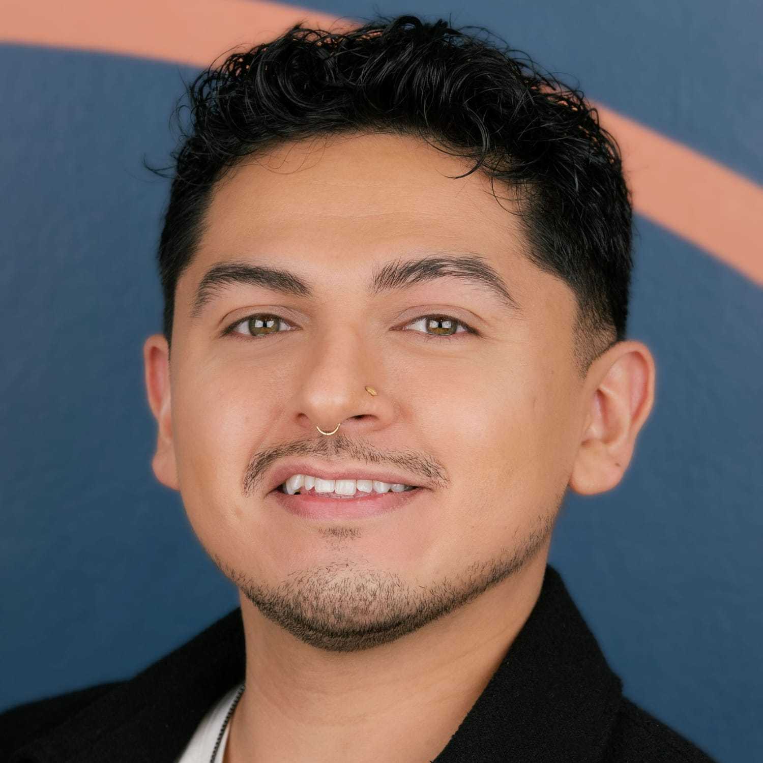 Portrait of Leo, a professional stylist at Mitchell & Co. Salon and Spa, showcasing their expertise and style.